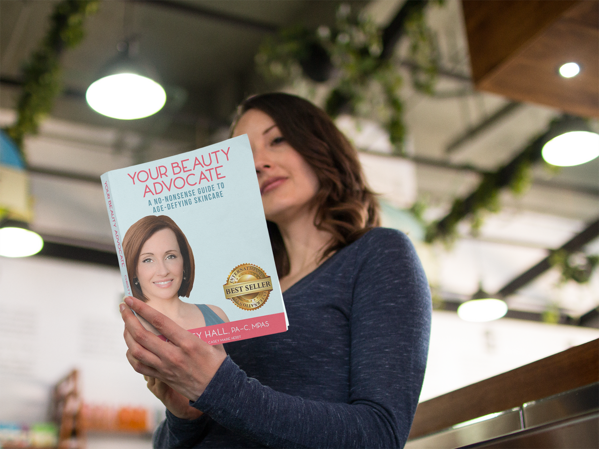 Bookstore Shopper Reading Your Beauty Advocate Book by Christy Hall | Shop Mikel Kristi Skincare